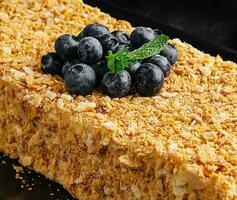 Napoleon cake decorated with blueberries and mint photo