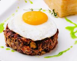 fried vegetable tartare with egg on plate photo