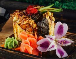 rice with vegetables wrapped in nori and drizzled with soy sauce photo