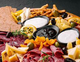 Wooden tray selection of italian antipasti photo