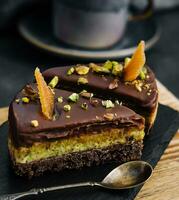 Slice pistachio cake on wooden board photo