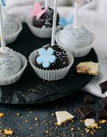 chocolate cupcakes on stone board with chocolate chips photo