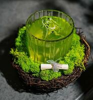 A green alcoholic drink in a clear glass photo