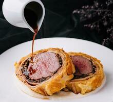 Fillet wellington in puff pastry on plate photo