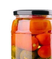 Salted cucumbers and tomatoes, in a glass jar photo