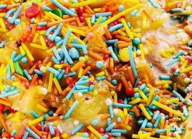 colorful sweet sprinkles on ice cream background photo
