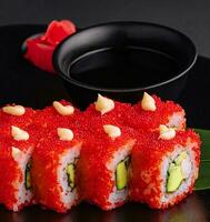 California Sushi roll cutting on black plate photo