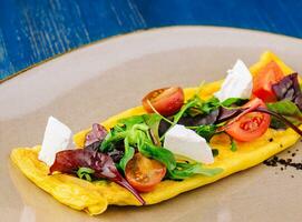 Omelette with cherry tomatoes and goat cheese photo