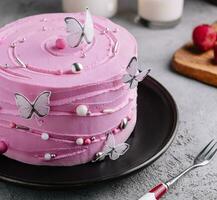 pink cake decoration in the form of butterflies photo