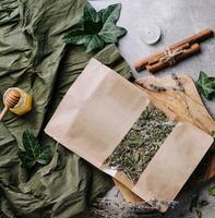 Dried and fresh tea leaves with tea, honey and cinnamon photo