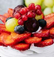 Mini pavlova meringue cake decorated with fresh berries photo