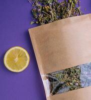 Dried and fresh tea leaves with lemon slices photo