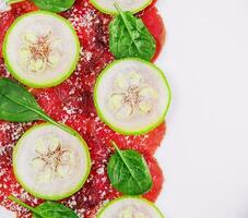 Italian beef carpaccio with sliced zucchini photo