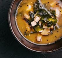 Soup with algae and mushrooms top view photo