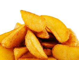 baked potato wedges close up on white background photo