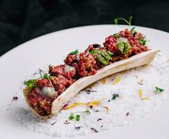 Exquisite serving beef tartare on plate photo