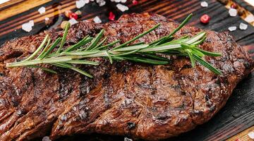 Grilled beef steak on wooden board photo