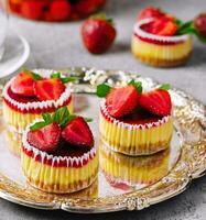 Mini strawberry cheesecake in muffin forms photo