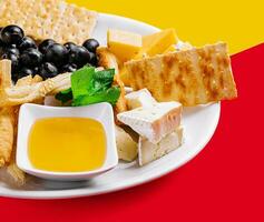 Different types of cheese on a white plate photo