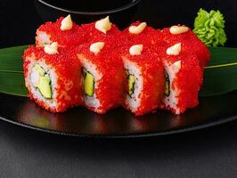 California Sushi roll cutting on black plate photo