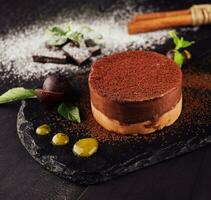 Mango and chocolate mousse on wooden black photo