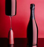 concept of two bottles and glass of red rose champagne photo