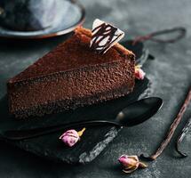 Chocolate cheesecake on black stone board photo