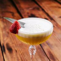 sweet alcoholic orange cocktail with foam photo