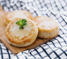 Cottage cheese pancakes on board close up photo