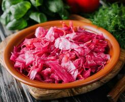 Salad with cabbage and beetroot on wooden table photo