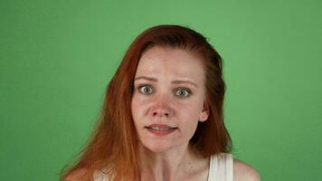Angry red haired woman on green chromakey video