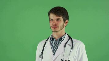 Happy male doctor smiling to the camera on chromakey video