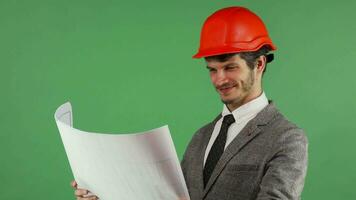 Happy architect examining his blueprints smiling joyfully video