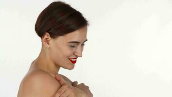 Gorgeous naked red lipped woman laughing, embracing herself video