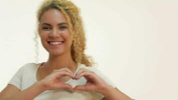 Red-haired girl showing heart shape gesture video