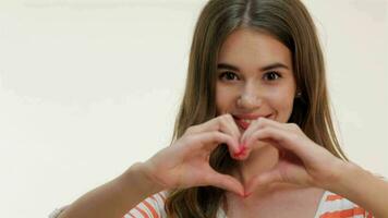 Young woman showing heart shape gesture video