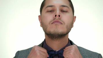 The well-dressed male straightens bow tie video