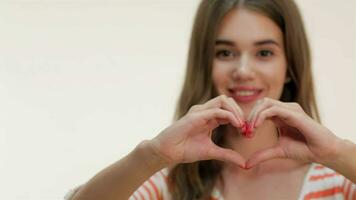 Attractive girl showing heart shape gesture video