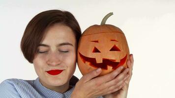 Beautiful woman cuddling with Halloween carved Jack pumpkin video