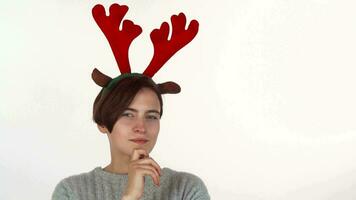 Attractive Christmas girl looking thoughtfully to the camera, isolated video