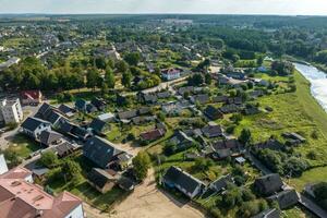 aerial view on provincial city or big village housing area with many buildings, roads and garden. photo