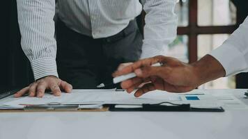 Group of confident business people point to graphs and charts to analyze market data, balance sheet, account, net profit to plan new sales strategies to increase production capacity. video