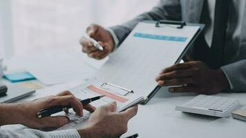 Group of confident business people point to graphs and charts to analyze market data, balance sheet, account, net profit to plan new sales strategies to increase production capacity. video