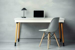 Table for working at a computer. Workplace at home. Desk with laptop, desk lamp and chair. Side view photo