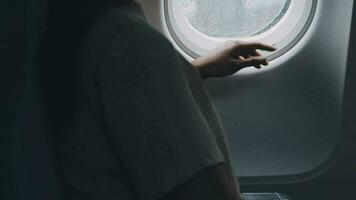 Plane cabin and a beautiful woman gazing out of the window video