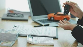Insurance officers hand over the car keys after the tenant. have signed an auto insurance document or a lease or agreement document Buying or selling a new or used car with a car video