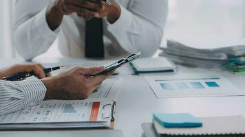 Group of confident business people point to graphs and charts to analyze market data, balance sheet, account, net profit to plan new sales strategies to increase production capacity. video