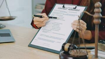 Lawyer, legal advisor, businessman brainstorming information on agreement details Business contracts in legal processing books for accuracy in contract documents. joint financial investment. video