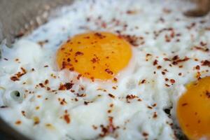 Fried eggs in the plate close up , photo