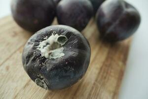 old damaged plums on a table photo